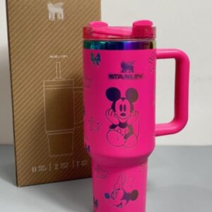 Gourde Stanley Flowstate Tumbler 40 oz avec anse — rose fuchsia avec motifs sombres et bande métallique irisée, motif personnage rond assis à grande tête et