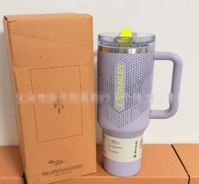 Gourde Stanley Quencher Tumbler avec anse — mauve / lilas, anse mauve, bouton jaune fluo, motif géométrique de petits triangles en